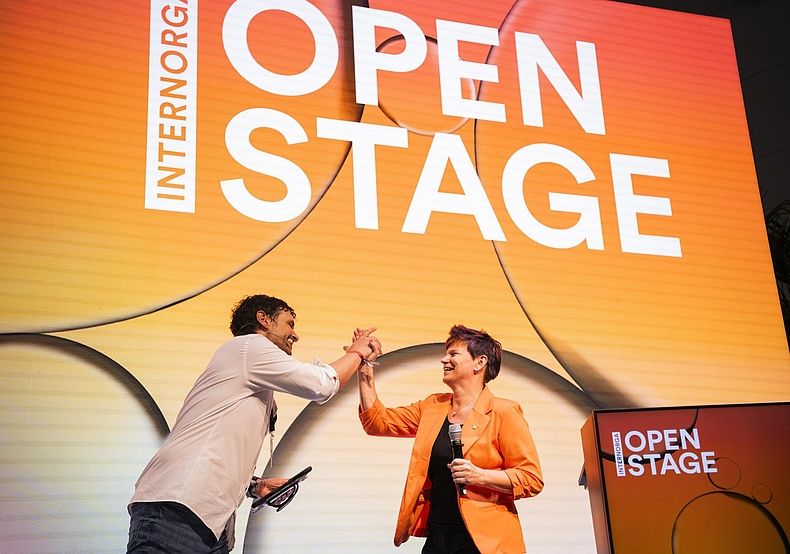 Open Stage close-up with two speakers giving each other a high five